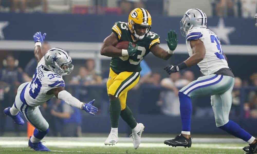 Oct 8, 2017; Arlington, TX, USA; Green Bay Packers running back Aaron Jones (33) runs against Dallas Cowboys safety Byron Jones (31) in the third quarter at AT&T Stadium. Mandatory Credit: Tim Heitman-USA TODAY Sports