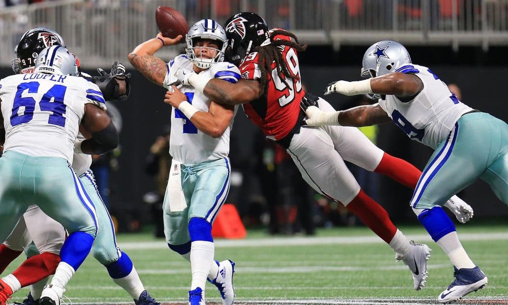 ATLANTA, GA - NOVEMBER 12: Dak Prescott #4 of the Dallas Cowboys is hit by Adrian Clayborn #99 of the Atlanta Falcons while throwing during the first half at Mercedes-Benz Stadium on November 12, 2017 in Atlanta, Georgia. (Photo by Daniel Shirey/Getty Images)