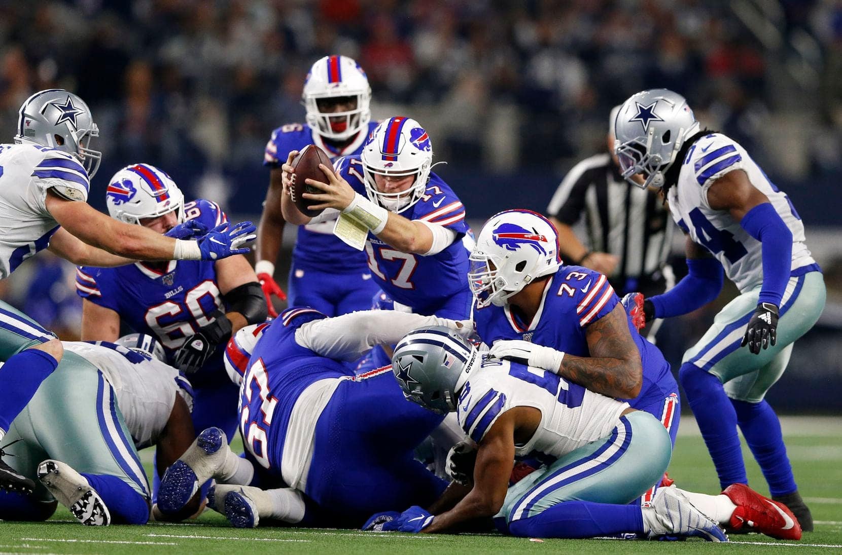 Bills' QB Josh Allen stretches for a 1st down in a game vs the Cowboys