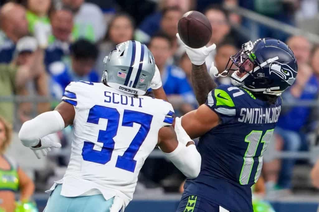 Seattle Seahawks wide receiver Jaxon Smith-Njigba catches a pass in front of Dallas Cowboys cornerback Eric Scott Jr. during the first half of a preseason NFL football game Saturday, Aug. 19, 2023, in Seattle. (AP Photo/Lindsey Wasson)