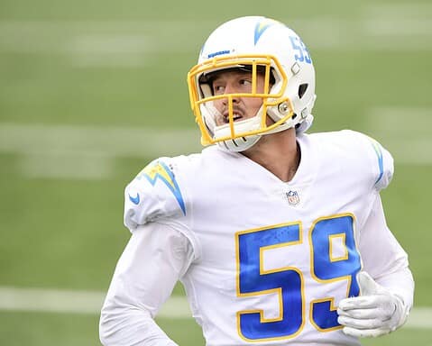 Football player wearing a white and yellow uniform with number 59 on the field.