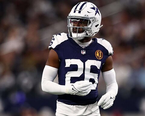 NFL player wearing Dallas Cowboys uniform during game.