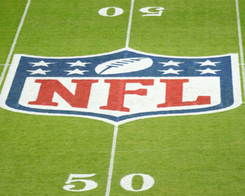 The NFL logo proudly adorns the 50-yard line, flanked by yard markers on lush green turf, as if waiting for a flawless play from the Dallas Cowboys.