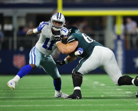 In Week 10, two football players clashed on the field—one in white and blue, representing the Cowboys, and the other in green and white for the Eagles.