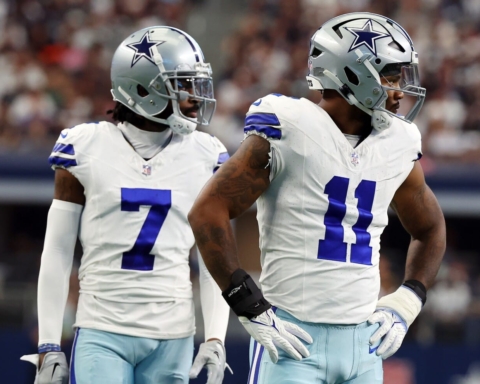 Two American football players in Dallas Cowboys uniforms stand poised on the field during a Week 12 game, showcasing the strength of the Cowboys defense.