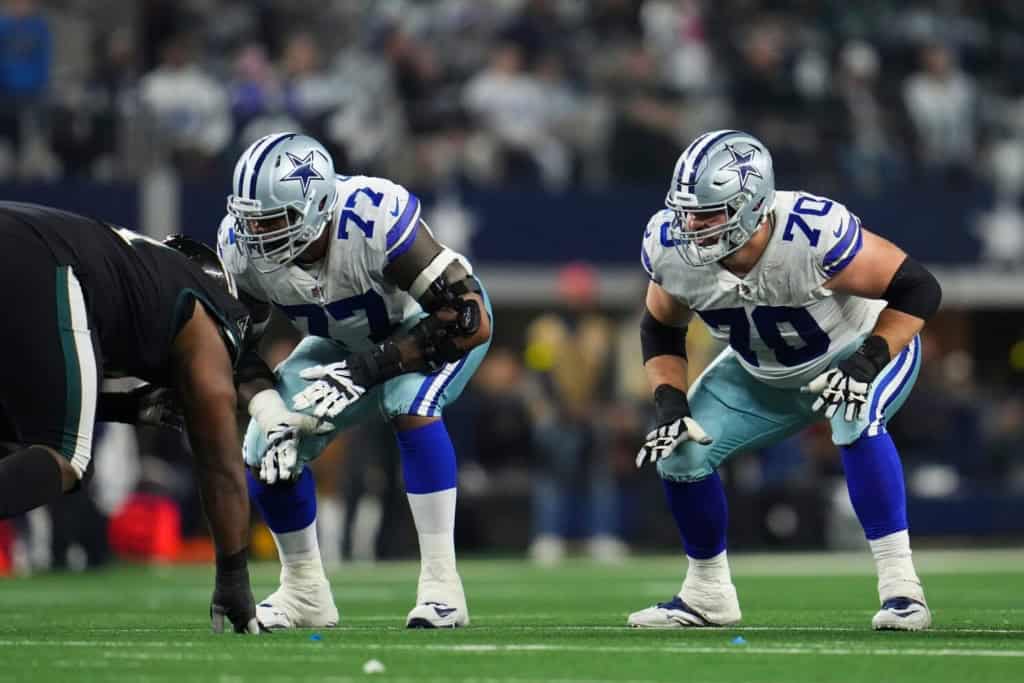 ARLINGTON, TX - DECEMBER 24: Tyron Smith #77 of the Dallas Cowboys and Zack Martin #70 get set against the Philadelphia Eagles at AT&T Stadium on December 24, 2022 in Arlington, Texas. (Photo by Cooper Neill/Getty Images)
