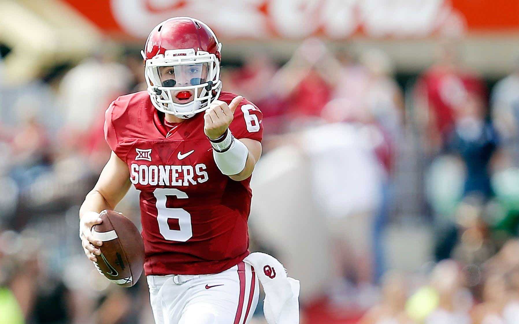 Burst of a college football player from Oklahoma Sooners, in red uniform with number 6, holding football, running on field, stadium blurred background, during game, athletic, intense action, NCAA football.