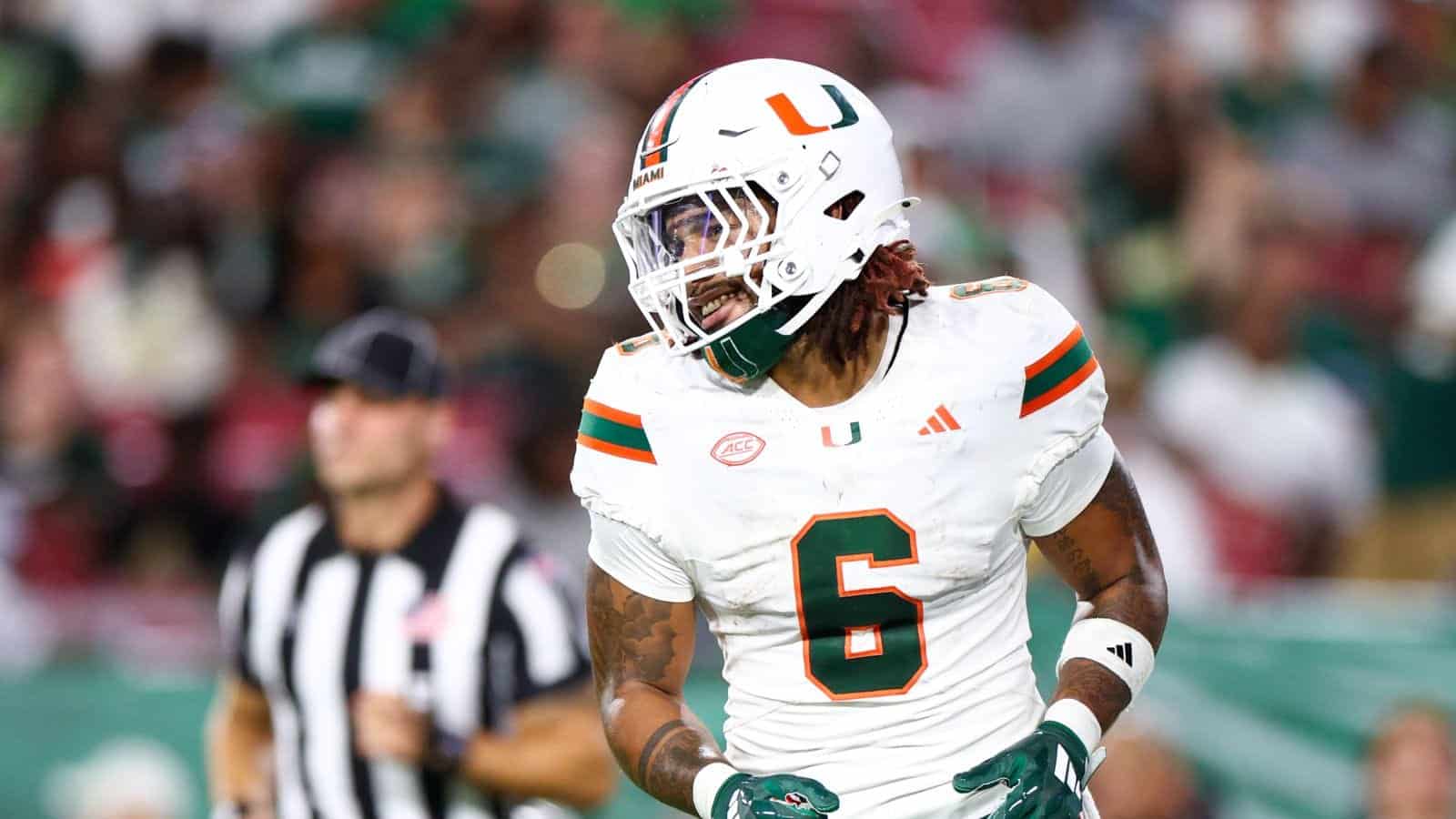 Exciting moment of Miami Hurricanes football player celebrating on the field during a game.