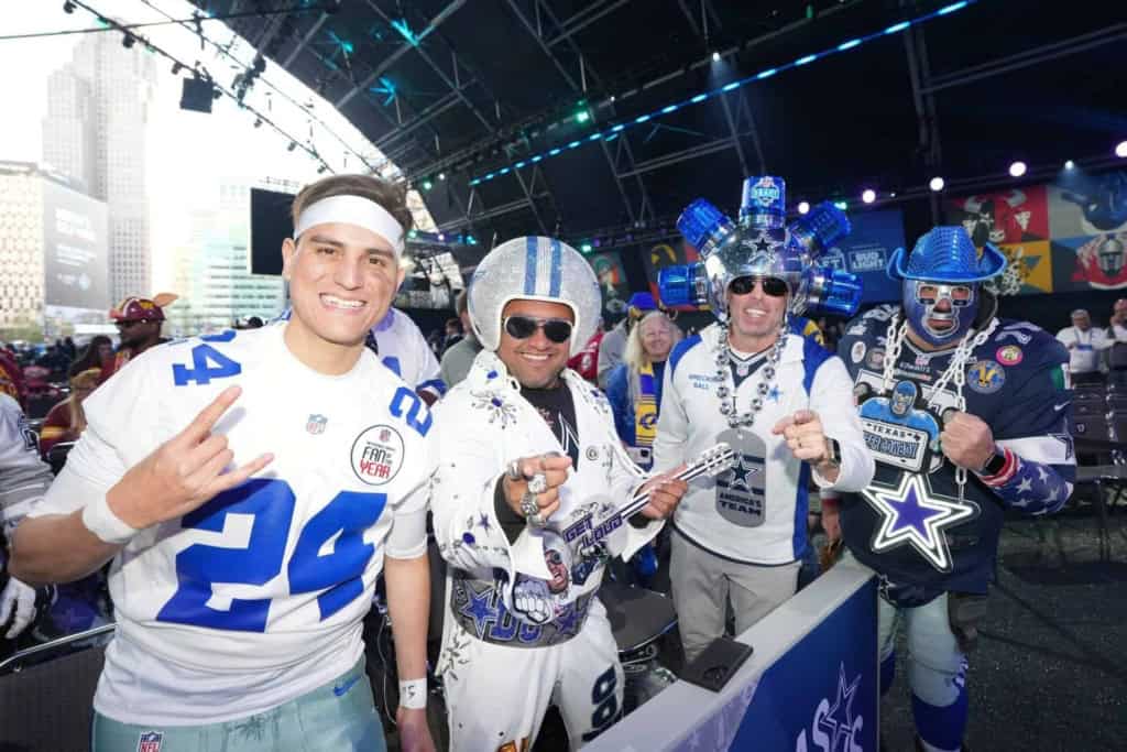 Celebrating Dallas Cowboys fans in colorful costumes at Inside The Star with team pride and NFL enthusiasm.