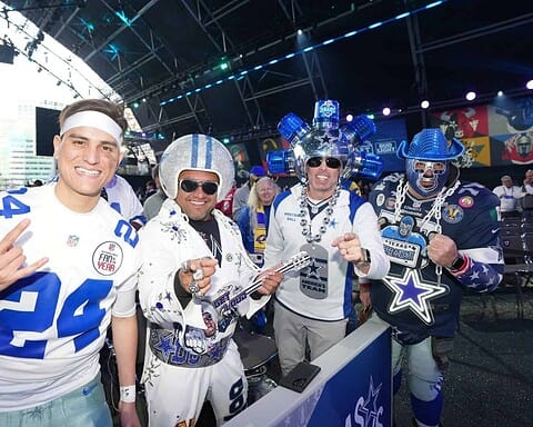 Celebrating Dallas Cowboys fans in colorful costumes at Inside The Star with team pride and NFL enthusiasm.
