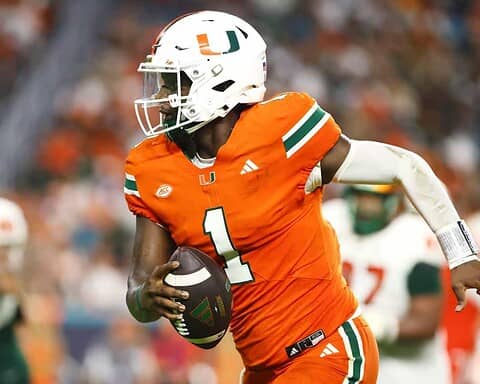 Miami Hurricanes football player in orange jersey with number 1, running with football during game on field.