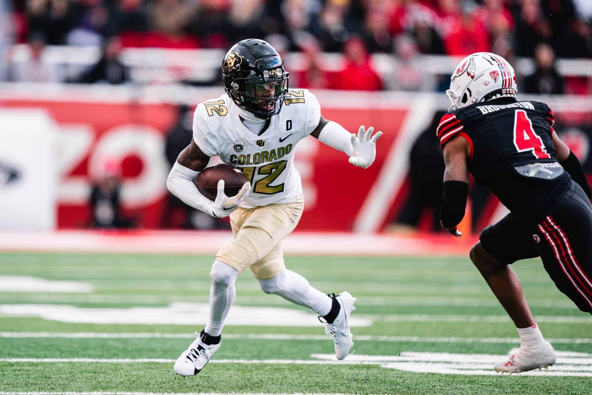 Elevated action shot of a Colorado Buffaloes football player running with the ball during a game against the Utah Utes, showcasing intense athleticism and team spirit.