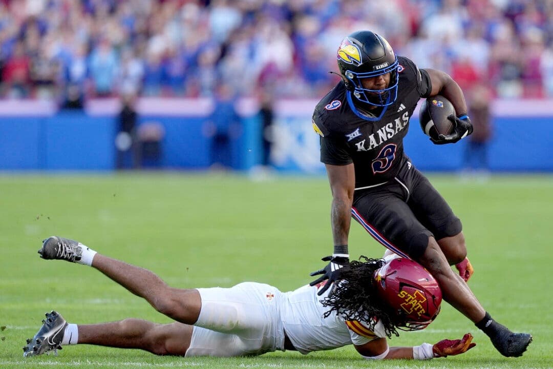 Who will Dallas miss out on in the draft’s 4th round? Kansas running back Daniel Hishaw Jr. (9) is tackled by Iowa State defensive back Jamison Patton (2) during the first half of an NCAA college football game Saturday, Nov. 9, 2024, in Kansas City, Mo. (AP Photo/Charlie Riedel)