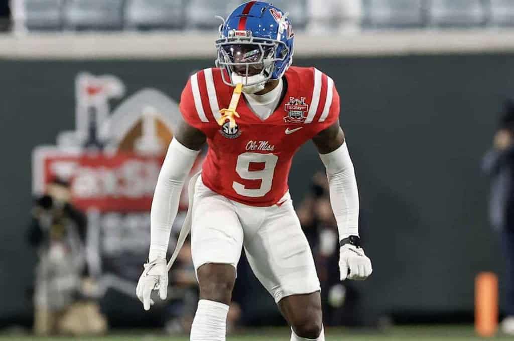 Dynamic football player in Ole Miss uniform during game action at Inside The Star, highlighting college football, game day, athlete performance, and sports fan experience.