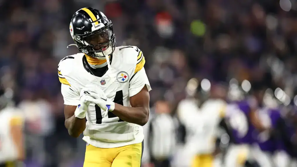 Dynamic NFL player in Pittsburgh Steelers uniform during game, showcasing athleticism on the football field.