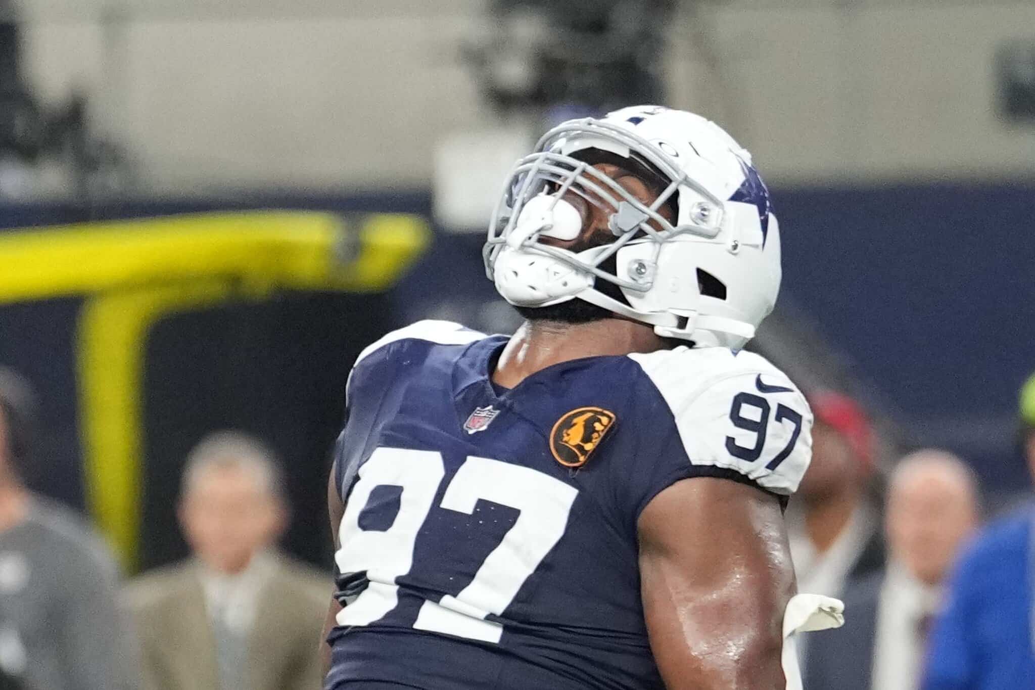 High school football player wearing Dallas Cowboys helmet and jersey number 97 on the field.