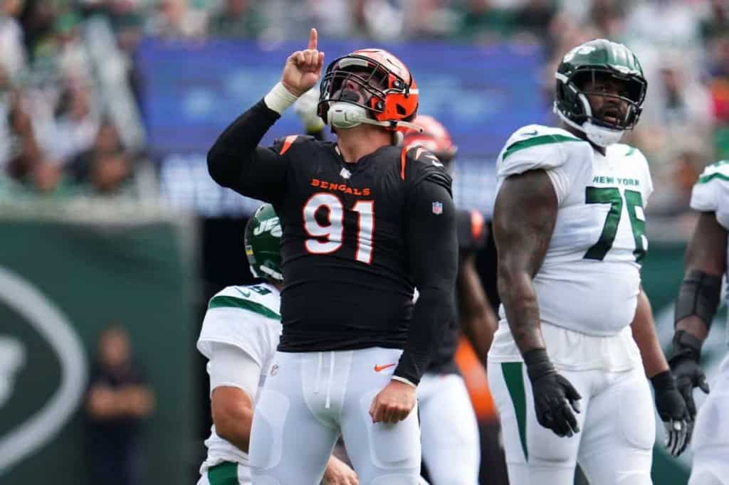 Cincinnati Bengals player celebrating a touchdown during an NFL game against the New York Jets, with teammates and crowd in the background.