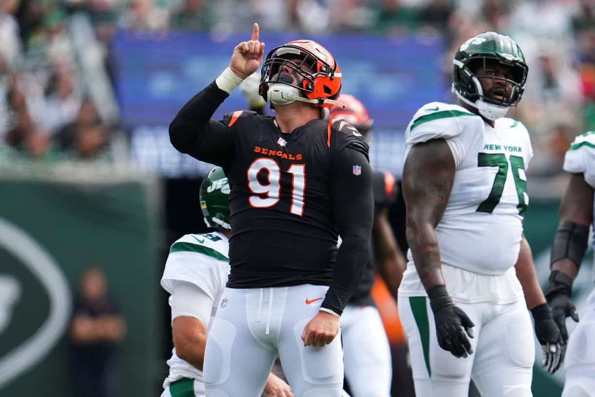 Cincinnati Bengals player celebrating a touchdown during an NFL game against the New York Jets, with teammates and crowd in the background.