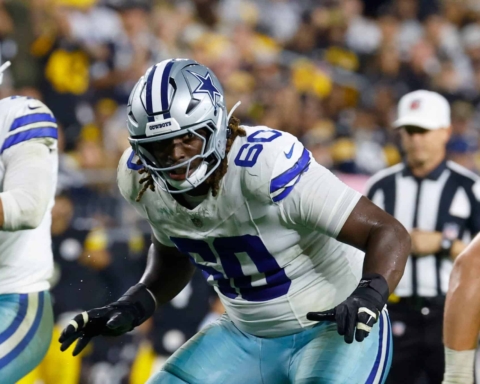 Dallas Cowboys football player wearing jersey number 90 during a game, showcasing team uniforms and intense sports action on the field.