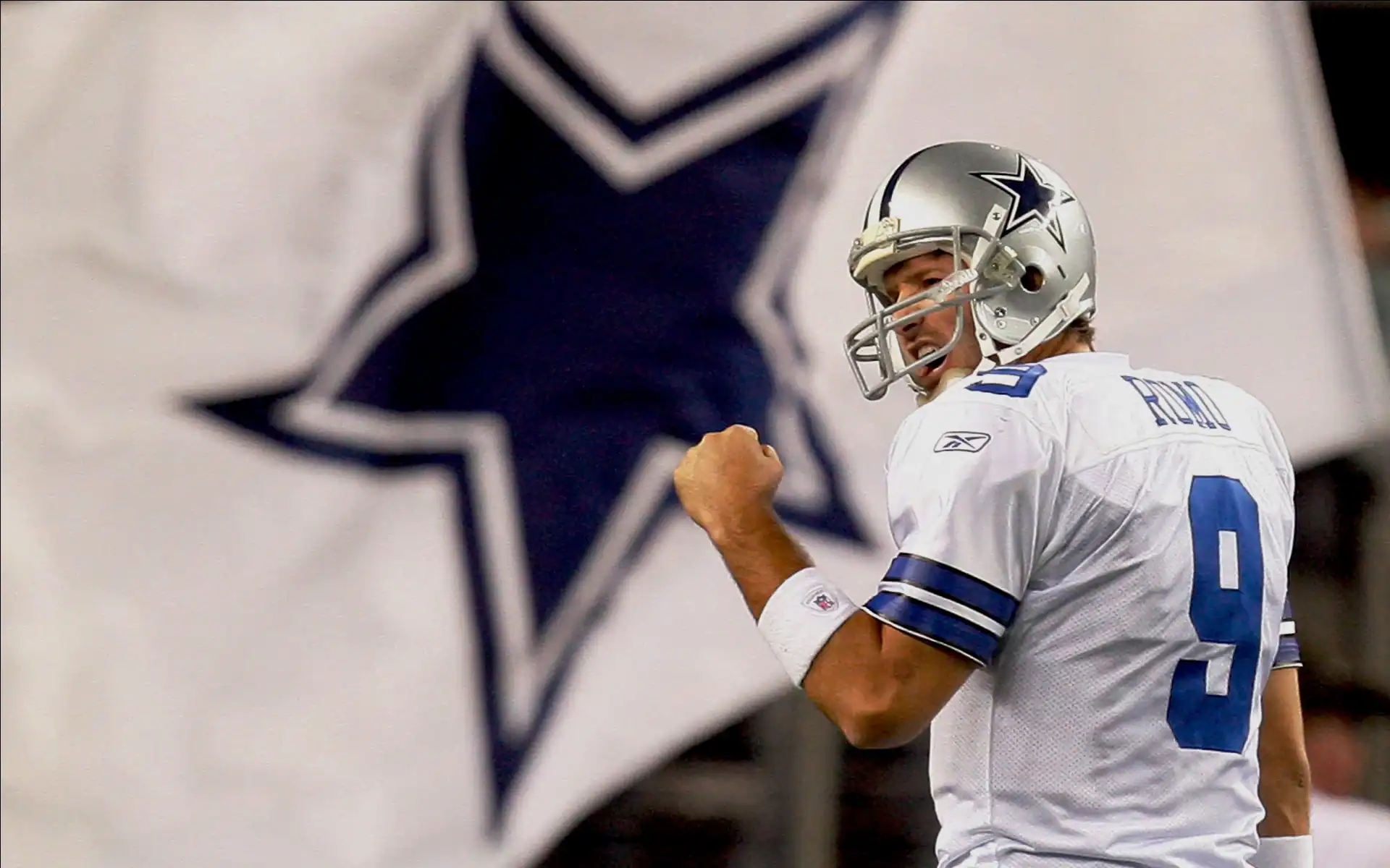 Celebrating a football victory with Dallas Cowboys player Dak Prescott in a game, showcasing team pride and excitement on the field.