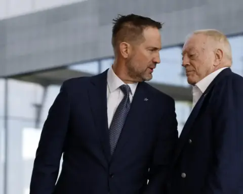 Focused Dallas Cowboys executives in formal suits engaging in a close discussion outside the stadium, emphasizing team management, leadership, and NFL team operational insights.