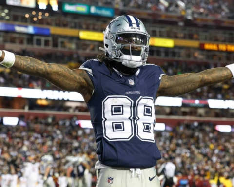 Celebrating a touchdown: Dallas Cowboys wide receiver with arms outstretched on the field during an NFL game at AT&T Stadium. Famous for game-winning plays and team spirit, this moment captures the excitement of professional football.