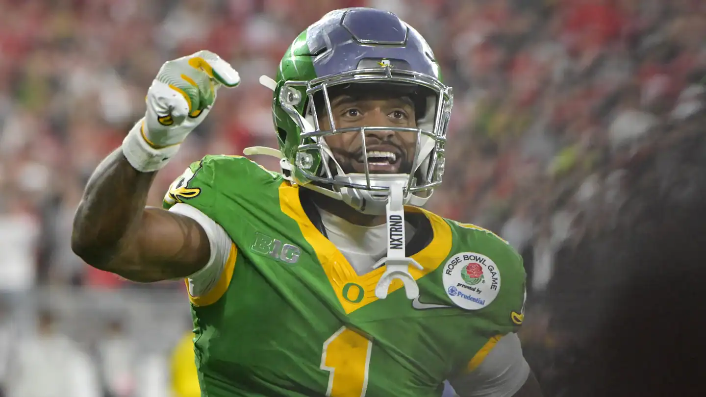 Vikings football player celebrating on the field in green uniform with a helmet and gloves, during a game, representing the Minnesota Vikings team, inside The Star sports complex.