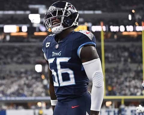 Line 1: Houston Texans football player wearing navy blue jersey and helmet during game on field.