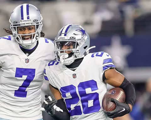 Celebrating Dallas Cowboys football players on the field during a game, highlighting team spirit, game action, and NFL football intensity.