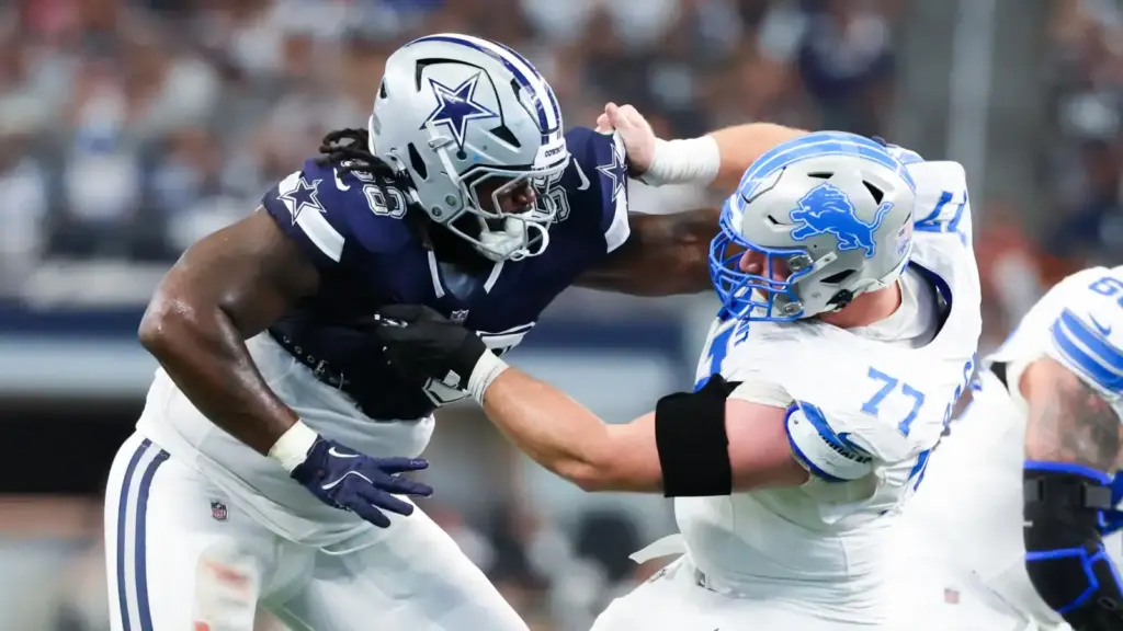 Dallas Cowboys linebacker engaging with Detroit Lions offensive lineman in a tackle during an NFL game. Intense moment showcasing NFL football action, players in full gear on the field, highlighting team rivalry and competitive gameplay.