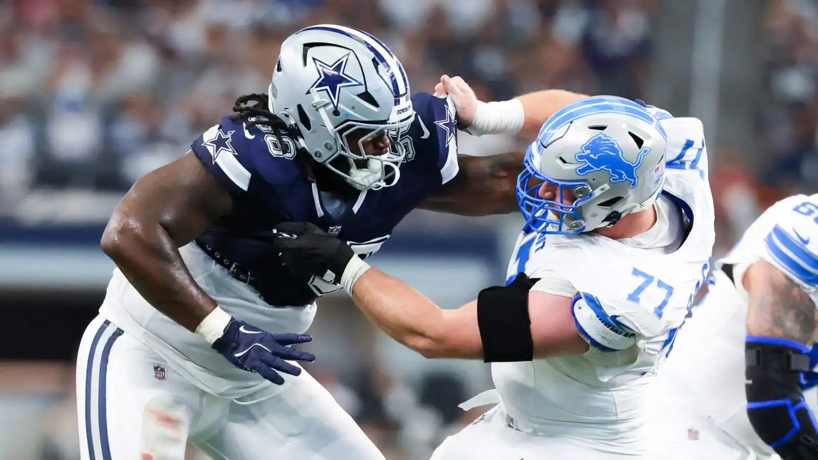 Dallas Cowboys linebacker engaging with Detroit Lions offensive lineman in a tackle during an NFL game. Intense moment showcasing NFL football action, players in full gear on the field, highlighting team rivalry and competitive gameplay.
