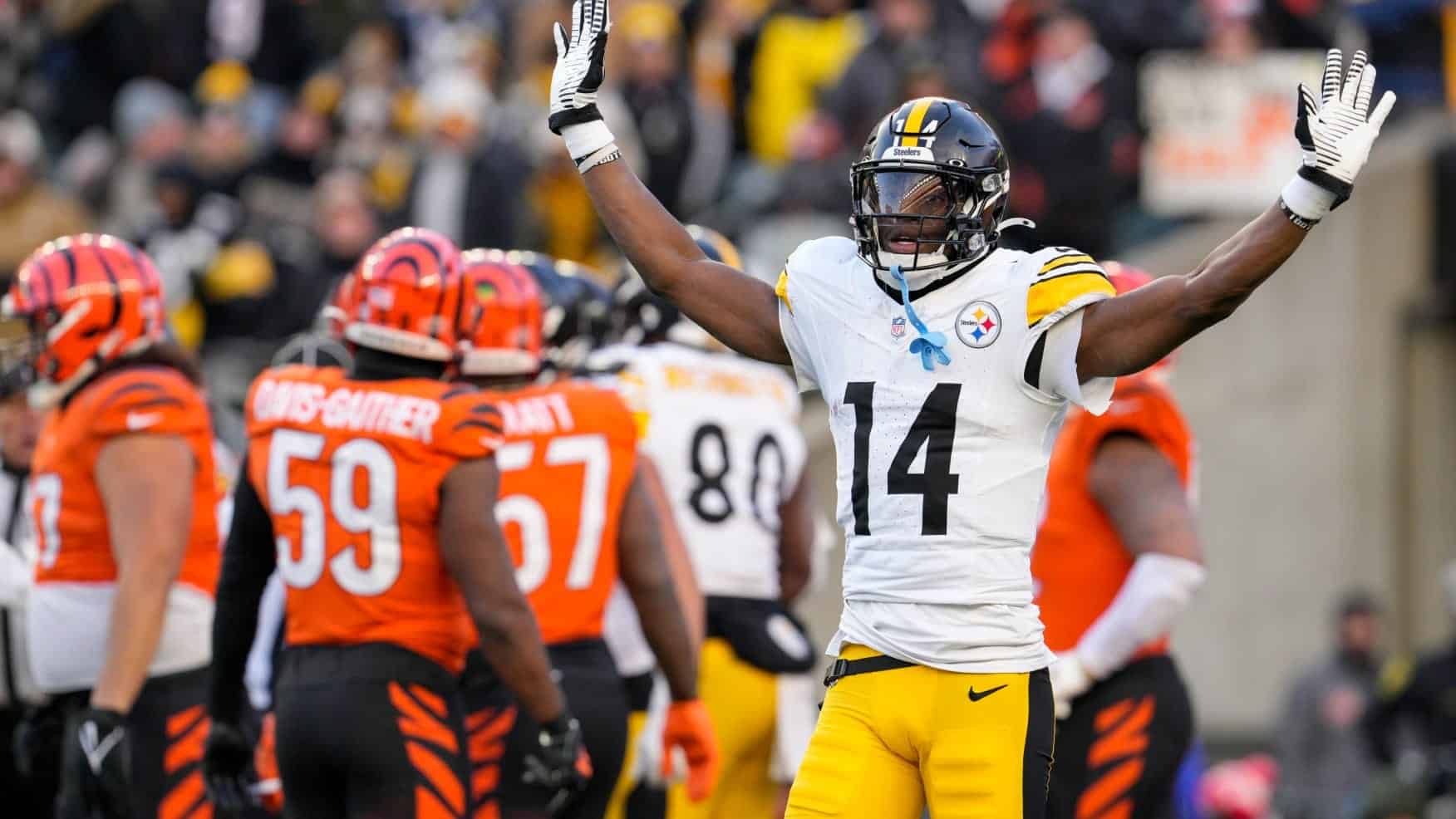 Celebrating a touchdown on the football field, inside the star, with players from the Pittsburgh Steelers and Cincinnati Bengals in the background.