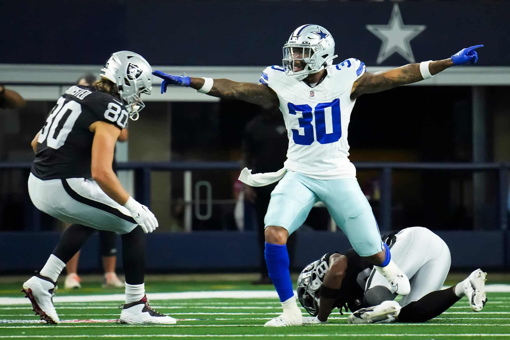 "Inside The Star" Dallas Cowboys football game with players celebrating a touchdown on the field, showcasing NFL action, team uniforms, and player emotions in a professional football stadium.