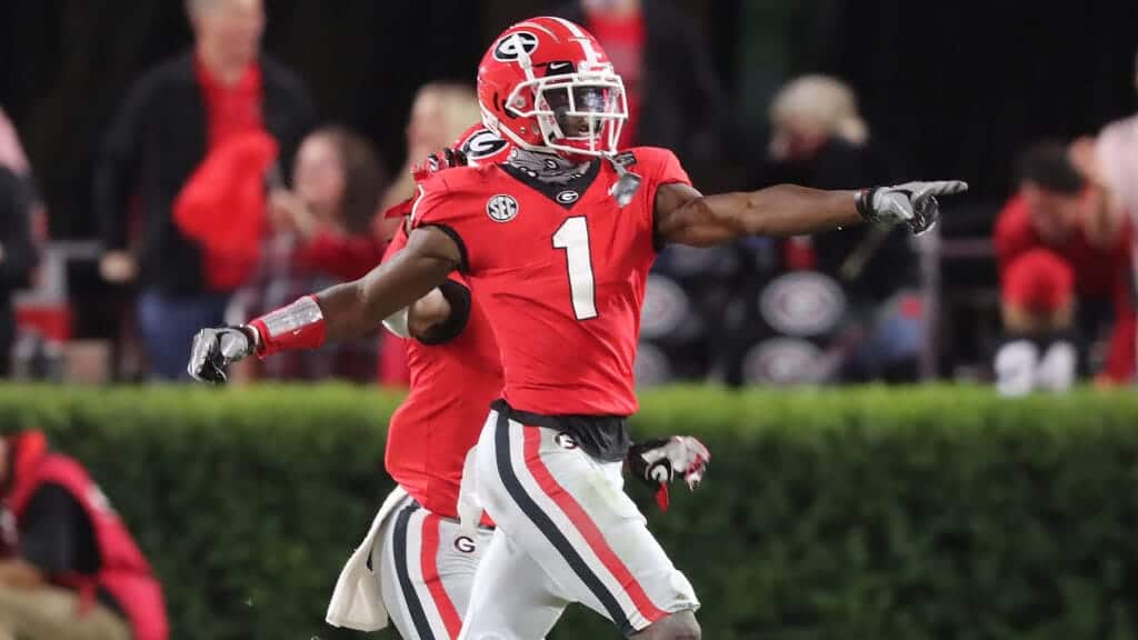 Receiver in red Georgia Bulldogs football uniform pointing on the field at a game Inside The Star.