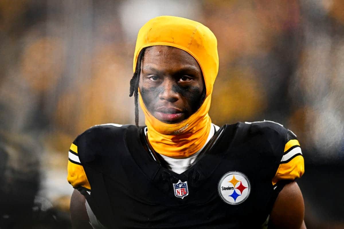 Young African American football player wearing Steelers uniform with yellow head covering and face paint, focusing on game day, NFL athlete, inside the star, Pittsburgh Steelers player, sports photography.