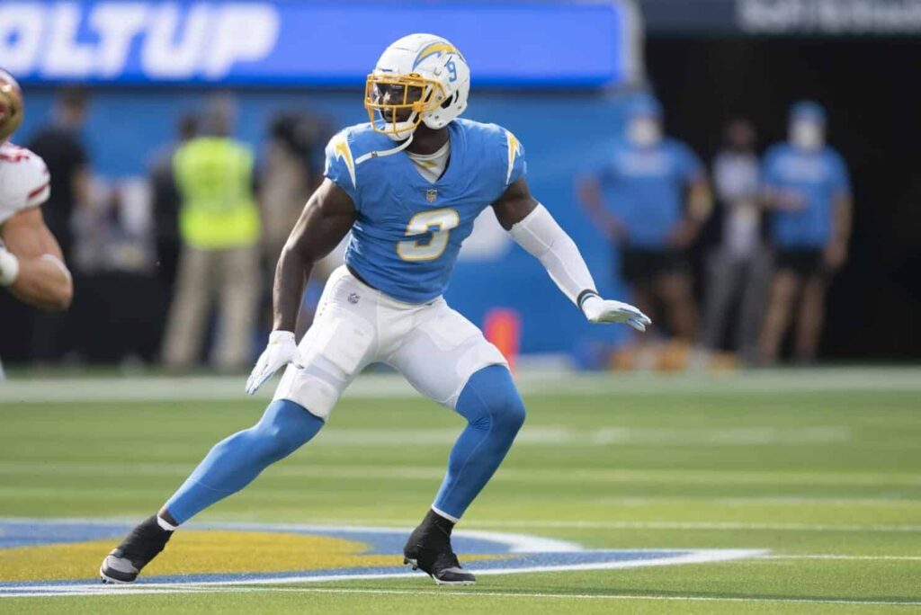 Fast-paced football game featuring a Los Angeles Chargers player preparing for the next play, wearing their team uniform and helmet on the field during an NFL game.