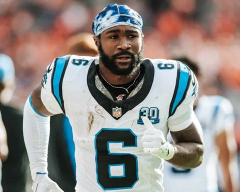 Derrick Brown during an NFL game, wearing his Carolina Panthers jersey, on the football field.