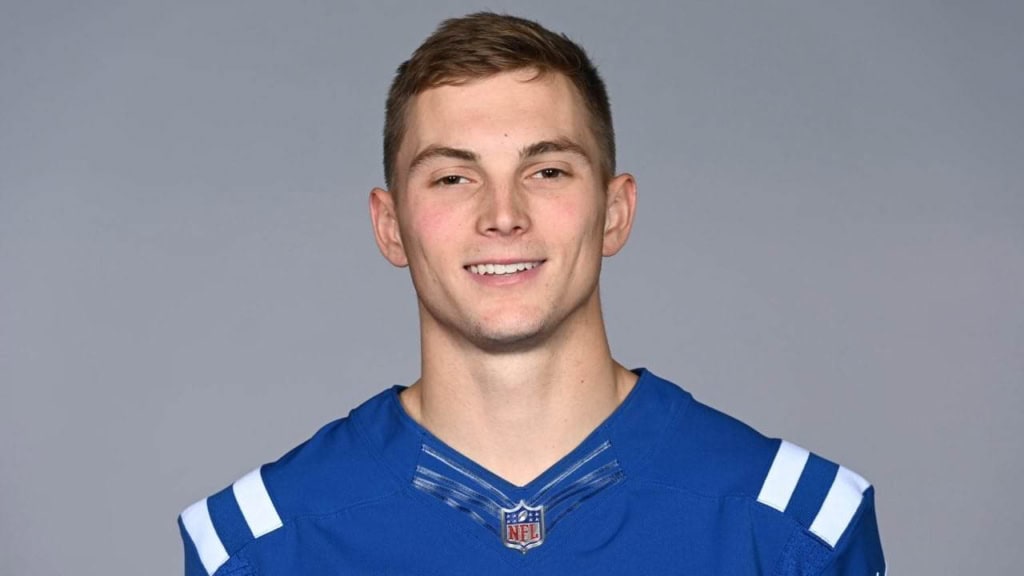 Young male football player in Dallas Cowboys jersey smiling for inside the star sports coverage.