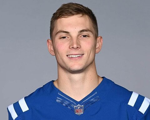 Young male football player in Dallas Cowboys jersey smiling for inside the star sports coverage.