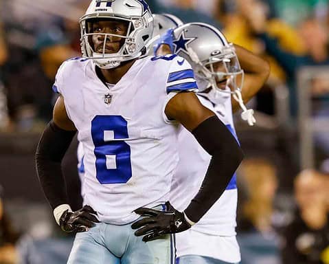 Vitality of a Dallas Cowboys football player during a game, wearing a helmet and jersey number 6, with a focused expression on the field.