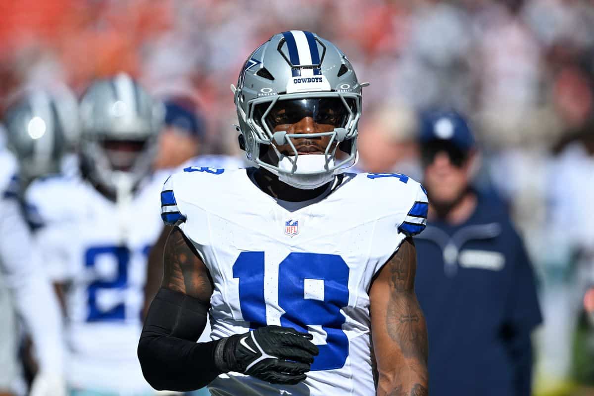 Wide receiver CeeDee Lamb of the Dallas Cowboys on the field during an NFL game, wearing team uniform and helmet, showcasing football action and team gear.