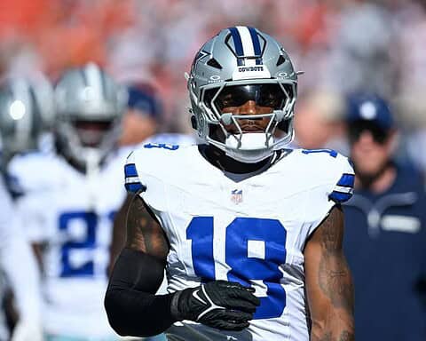 Dallas Cowboys wide receiver wearing helmet and jersey on the football field during game.