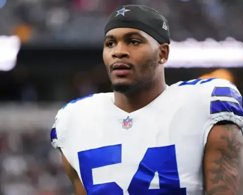 Young African American football player wearing Dallas Cowboys uniform with number 54 on the field during a game.
