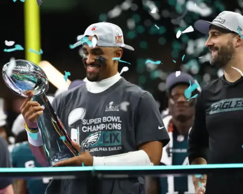 Celebrating Philadelphia Eagles Super Bowl victory with team members holding the Vince Lombardi Trophy, surrounded by confetti and joyous fans, highlighting NFL championship success.
