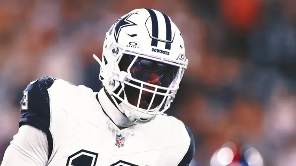 Dallas Cowboys football player in full gear on the field during a game.