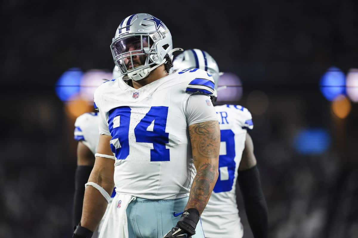 Dallas Cowboys football player wearing number 94 on a night game field.