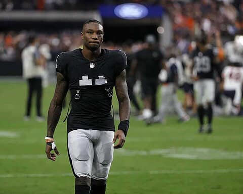 Athletic football player walking on the field in Dallas Cowboys uniform during a game, showcasing NFL sports action and Dallas Cowboys team spirit.