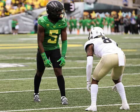 Behind the scenes of college football, players from Oregon Ducks and New Orleans Saints face off on the field during a game, showcasing athleticism and intense competition.