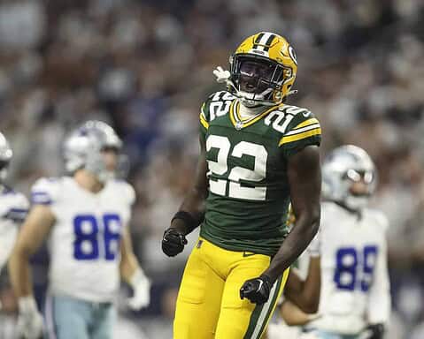 Green Bay Packers football player celebrating on the field during an NFL game.