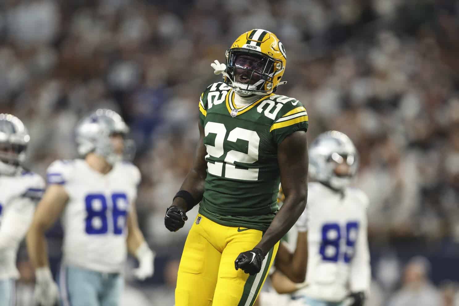 Green Bay Packers football player celebrating on the field during an NFL game.